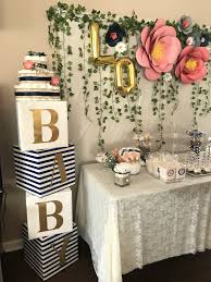 Homemade baby shower decorations can be just as beautiful as store bought items you pay a small fortune for. Baby Shower Floral Decor Baby Blocks And Large Paper Flower Diy Simple Baby Shower Baby Shower Flowers Baby Shower Diy