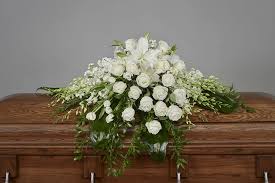 Wooden vintage casket, envelope, pen, red hearts of cardboard and white spring flowers on a white background. White Casket Spray Ramsgate Floral Designs