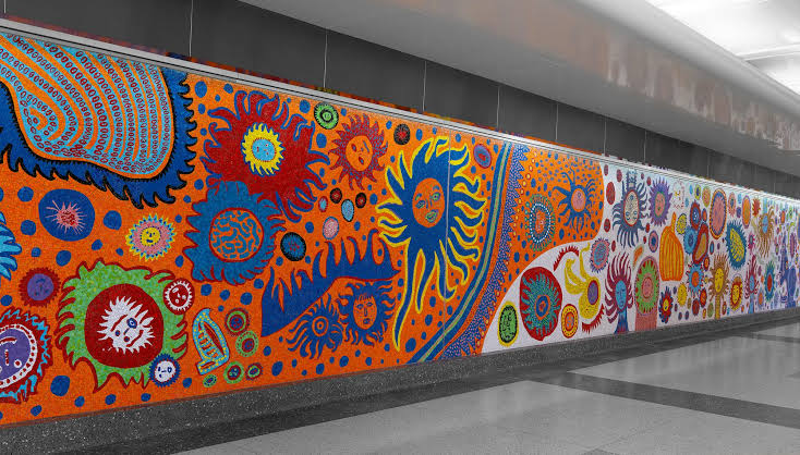 Smiling suns and faces fill A Message of Love, Directly from My Heart unto the Universe (2022), Yayoi Kusama public art in glass mosaic in New York.