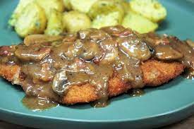 For anyone unfamiliar with schnitzel, they're made by pounding boneless pork chops very thin, breading them in flour, egg and breadcrumbs and frying. Pork Schnitzel Mushroom Gravy Cook2eatwell