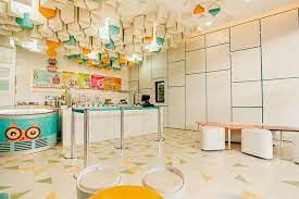 A big menu board hangs above the counter and display case.click here to see all scenes containing this background. Ice Cream Shop Interior Design Recreates The Look Of Stalactites Mindful Design Consulting
