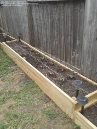Looking for flower beds ideas to add texture and color to your backyard or front of your house? Fence Line Garden Use Of Lights And The Use Of Trellis Works Well Landscaping Along Fence Garden Ideas Along Fence Line Backyard Plants