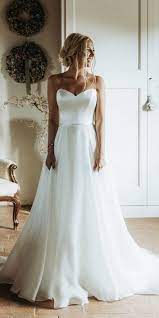 Exaggerated ruffle hem, tiered sleeve, mock neck with fabric covered buttons at back. 27 Silk Wedding Dresses For Elegant And Refined Bride Wedding Dresses Guide