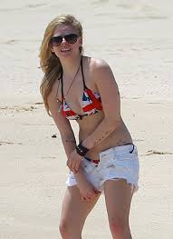 Indulge your desires with exclusive photos of Avril Lavigne in a range of swimwear heating up the tropical climate
