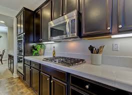 Kitchen with stainless steel countertops and a black grid backsplash. Kitchen Trends 12 Ideas You Might Regret Bob Vila