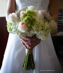 Look through magazines, books on floral decorating, visit fine floral shops, and take pictures of floral lay seasonal greens such as pine boughs or ivy fronds on a tray with candles, beaded fruit, and a few fresh flowers in vials of water. Wedding Bouquets Vickies Flowers Brighton Colorado Florist