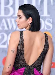 Palm tree tattoo on the back of her upper left arm. See All Of Dua Lipa S Tattoos And Learn Their Meanings Popsugar Beauty