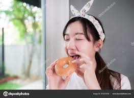 Happy Asian Young Woman Deliciously Biting Sweet Donut — Stock Photo ©  Seahorse_Photo_in_BKK #472273190