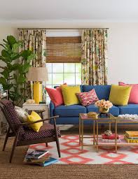 Layered rugs soften the space, while yellow living room accessories, including fresh flowers, a lampshade, and throw pillows, incorporate the sunny color scheme throughout. 23 Yellow Living Room Ideas For A Bright Happy Space Better Homes Gardens