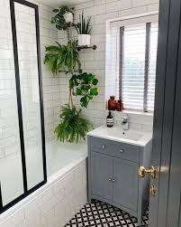 The gold hardware looks luxurious over white tiles. Bathroom Tile Design Ideas Decoholic