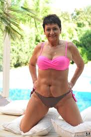 Brunette granny in a bikini Anastasia - Exposing her breasts poolside fun