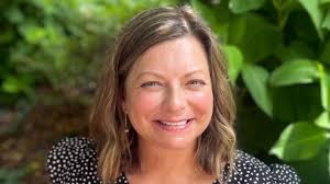 Nursing Assistant Teaching Professor Kristine Stewart-Perkins assists  passenger in need