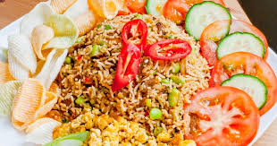 Indonesian Nasi Goreng Served With Veggie Chips Slices Of Cucumber And Tomato And Scrambled Tofu Fried Rice Nasi Goreng Recipe Indonesian Fried Rice Recipe