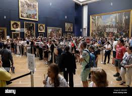 Paris, France - June 9, 2023: Tourists crowd to take photos of the famous Mona  Lisa painting of Leonardo da Vinci inside the Louvre museum Stock Photo -  Alamy