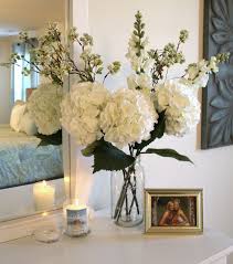 Displayed in a pair of wide glass vases, this bursting arrangement instantly brightens a sideboard. 24 Wonderful Ways To Decorate Your Home With Flowers Master Bedrooms Decor Home Decor Bedroom Decor