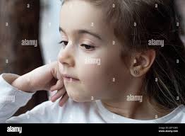 Little girl at a rainy window hi-res stock photography and images