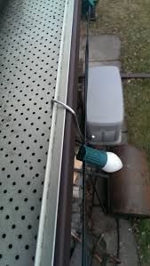 Looking Down On Perforated Gutter Guard Using Christmas Hook To Hang Christmas Lights Www Chri Hanging Christmas Lights Light Hanger Christmas Light Hangers