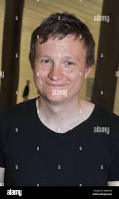 Swedish artist Andreas Eriksson poses in front of one of his works at the  Swedish pavilion