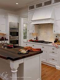 Dark wood countertops, open shelving with white dishes and that vintage stove. 12 Wow Worthy Woods For Kitchen Countertops Bob Vila