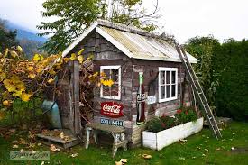 Well establish countryside backyard with small windowed yellow shed and surrounded by sunflower plants and lots of trees. Fairytale Backyards 30 Magical Garden Sheds