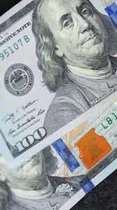 Closeup and detailed view of banknotes of different currencies and  denominations highlighting its intricate design and various security  features