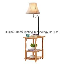 Two tiers of shelving are situated at the interior of this floor lamp's legs, giving you space to display décor or stash magazines and reading. China Jlf 23199 Home Living Room Wooden Shelf Floor Standing Lamp With End Table China Shelf Floor Lamp Floor Standing Lamp