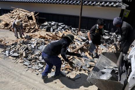 Rescue teams searching through the rubble of buildings affected by the recent earthquake in Japan.