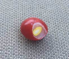 Skittles consist of hard sugar shells imprinted with the letter 's'. This Red Skittle Has A Yellow One Inside Of It Mildlyinteresting
