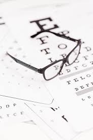 Close Up Of Corrective Spectacle On Snellen Chart Photo