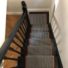 Striped Stair Runner Dark Spindles And Bannister Black Staircase Parquet Flooring Basement Staircase Striped Stair Runner Staircase Design Stairs