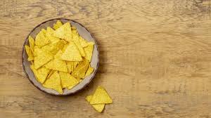 Download Pile Of Nachos On Plate On Wooden Table For Free En 2020