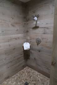 Shower wall application wood look tile accent walls are a great way to add texture to any space, but the contrast between that and sleek plumbing fixtures makes it especially effective in a bathroom remodel. Large Shower With Weathered Wood Look Tiles And Stone Floor Picture Of Hotel Indigo Traverse City Traverse City Tripadvisor