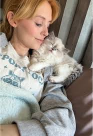 Petting a Newborn Kitten: Gentle Touch from a One-Year-Old