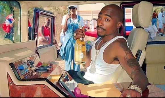 Rare 1996 photo of Tupac Shakur with Cristal in his Hummer