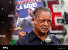 Rev. Jesse Jackson, right, speaks with reporters accompanied by Haitian  priest Gerard Jean Juste, supporter of former Haiti's President  Jean-Bertrand Aristide, after their meeting at the St. Claire church in  Port-au-Prince, Monday,