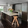 There are lots of contrasting finishes going on in this transitional kitchen—hardwood floors, a natural stone accent wall, dark grey cabinets and a waterfall marble island contribute to the unique rustic design. Https Encrypted Tbn0 Gstatic Com Images Q Tbn And9gcs 3gitimoq4klbr6cg5x63z7sbtghhdpatiram3txfn2or0m73 Usqp Cau