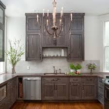 This is usually done by applying a coating of glazed over stained or painted cabinets, leaving a shadow effect on the cabinets surfaces. Shelf Over Kitchen Sink Cottage Kitchen