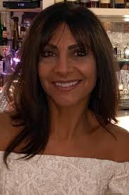 Mom is 89 yo and makes all her own clothes. Would you kindly change the  background to something stunning and beautiful? Surprise me!!!