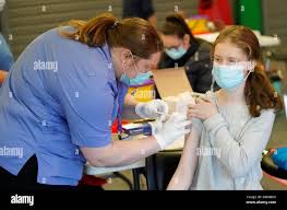 Nurse Amanda Sherwood administers a Covid-19 vaccine to Rachel McDowell  (16) at the Just the
