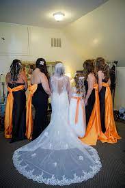 Beautiful Shot Of The Back Of The Bride And Bridesmaids Gowns Biker Wedding Dress Orange Bridesmaid Dresses Orange Dress Wedding
