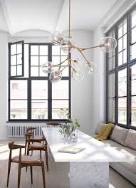 stijlvolle glazen bollen als verlichting boven de eettafel roomed avec lange eettafels 1 et grote lamp boven lange eettafels interieur woonkamer huis interieur