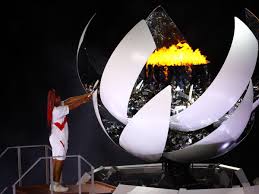 Naomi osaka walks up the steps to light the cauldron during the opening ceremony. R8kkogiijvshnm