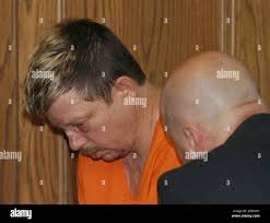 Stephen Talley, left, speaks with an Arkansas State Police official, in a  Pulaski District courtroom, Monday, Oct. 25, 2004, in Little Rock, Ark.  Talley pleaded innocent