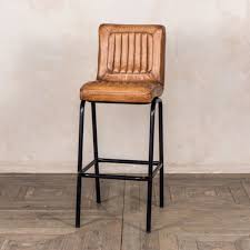 A luxury modern bar stool is the perfect casual seating furniture for both home and commercial dining and bar spaces. Jenson Distressed Leather Bar Stools Tan Trading Boundaries