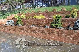 Classic Brick Retaining Wall For Your Patio Stone Patio Designs Stone Landscaping Outdoor Gardens