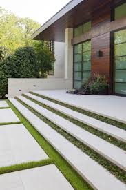 The stairs lead up to another patio at main floor level that has a. Facade Of A Modern Home Featuring Floating Concrete Stairs Separated By Grass Strips Hgtv