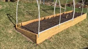 At one end of the hoop house, tie a rope around the middle leg of the connectors, then wind the rope once around the other two legs and take the rope down to the other end of the hoop house. Raised Garden Bed How To Make An Easy Access Cover Youtube