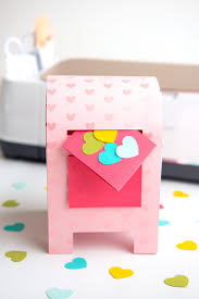 Use your hot glue gun to fasten the loop to the underside of the card box a few inches from one short end. Diy Valentine S Day Box With The Cricut Hey Let S Make Stuff