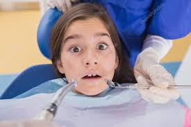 Dentist and his dental assistant examining a terrified young pat — Stock  Photo © Wavebreakmedia #65293631