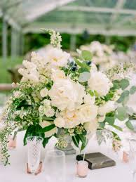 Elegant white wedding reception inspirations. A Lakeside Wedding Filled With Meaning Sweet Moments Wedding Flowers Low Wedding Centerpieces Fun Wedding Decor